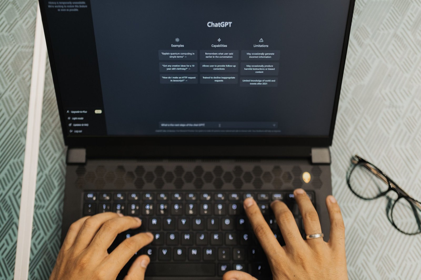 Person using ChatGPT on a laptop while researching business visibility in AI search
