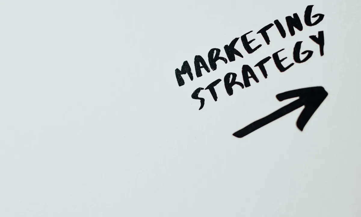 Marketing strategy lettering with an upward arrow