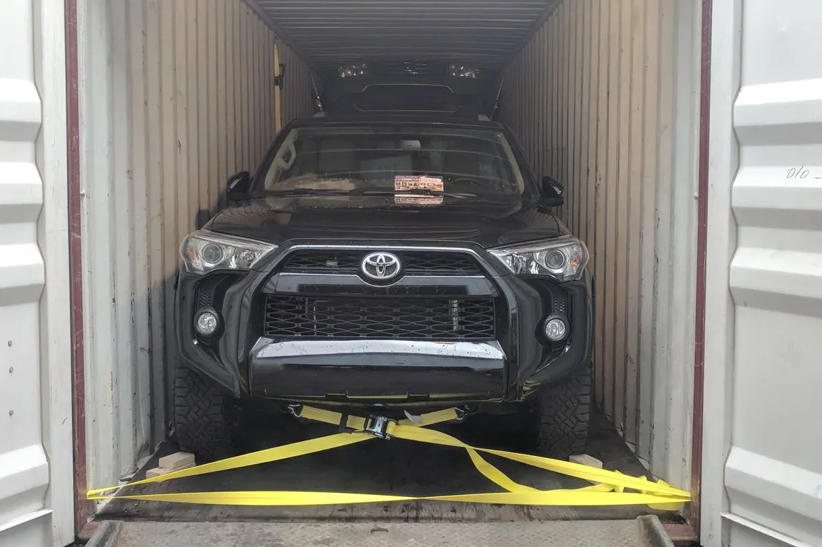 Vehicle secured inside a shipping container for international freight transport