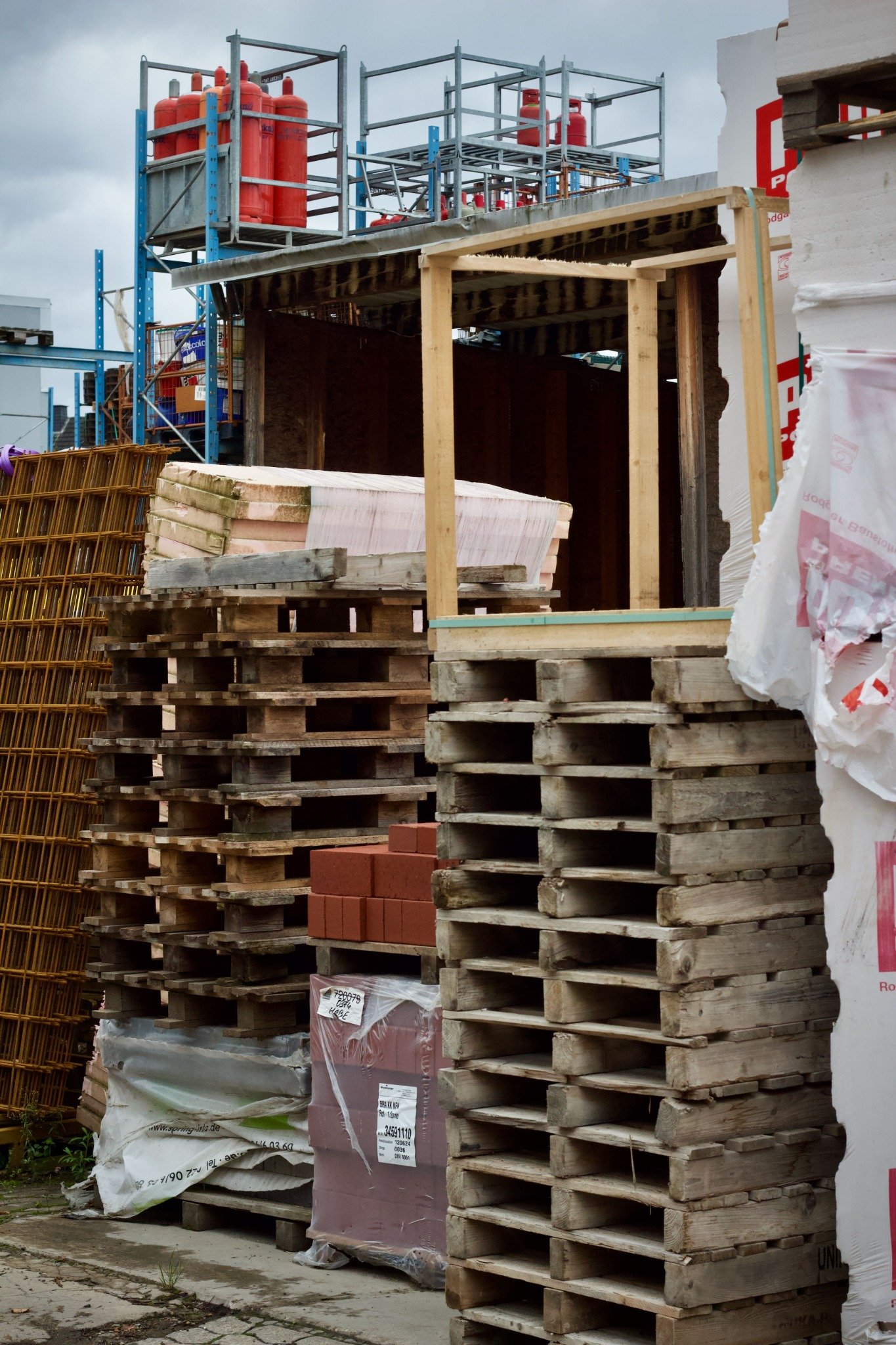Pallets and building materials stacked in a construction supply yard
