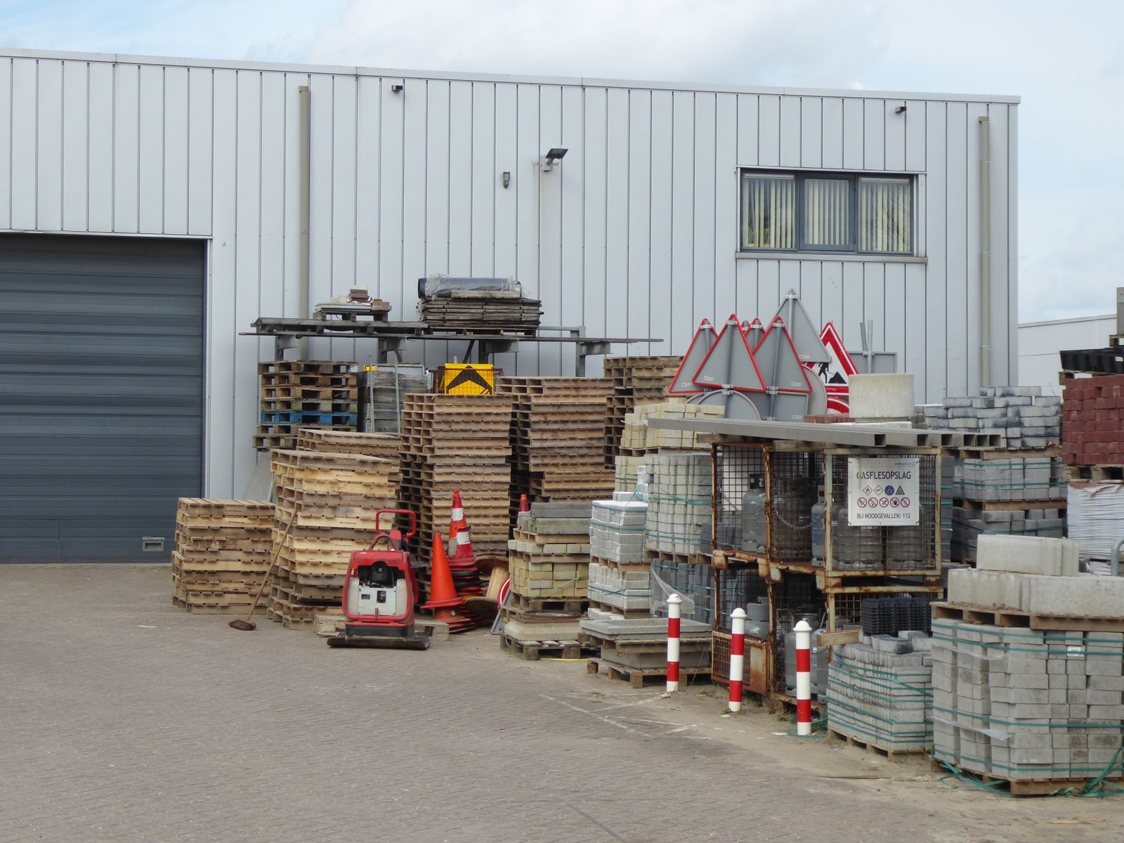 Building materials and equipment stored outside an industrial warehouse