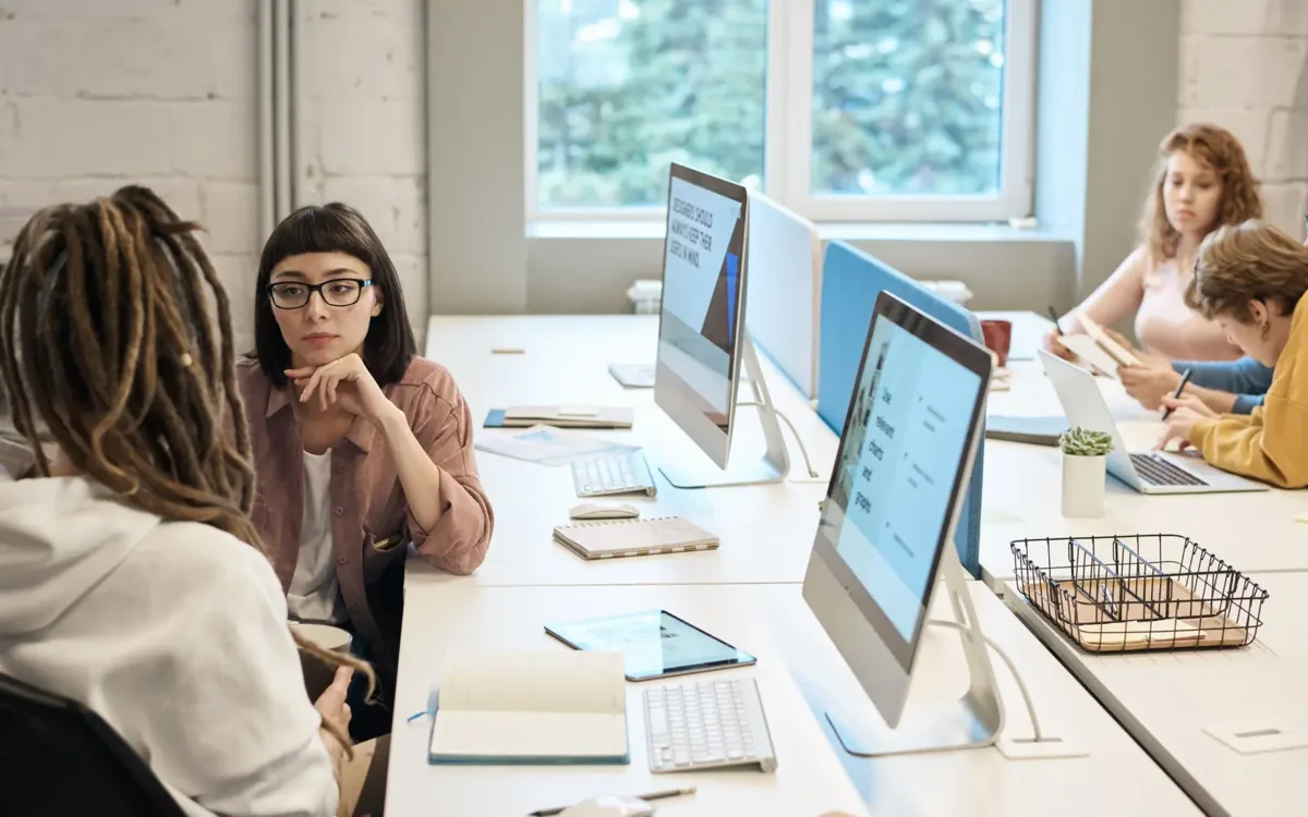 People working together at desktop computers.