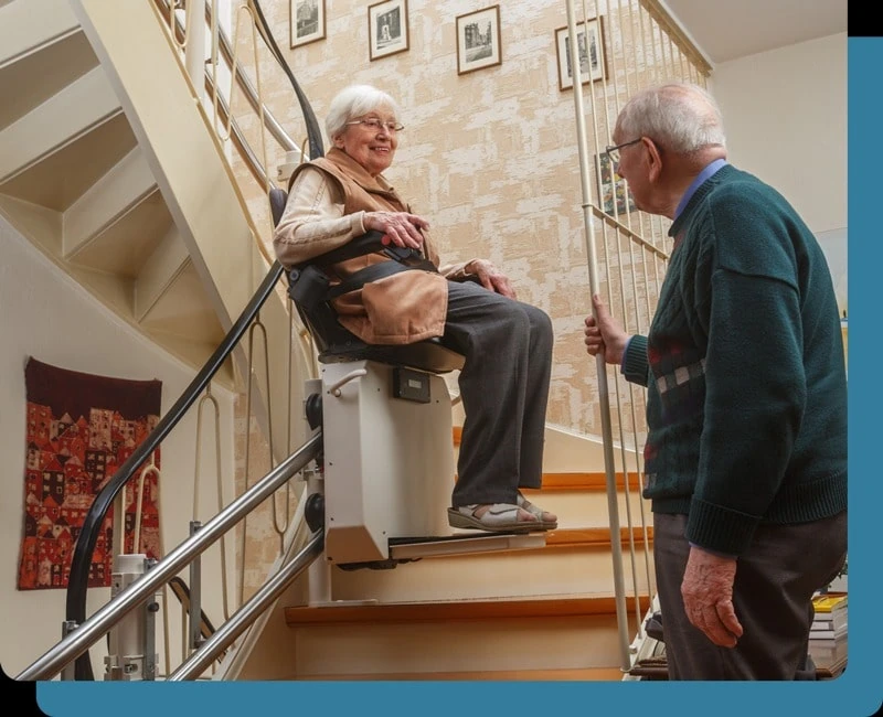 Stairlift installed in a home with an older adult using the lift