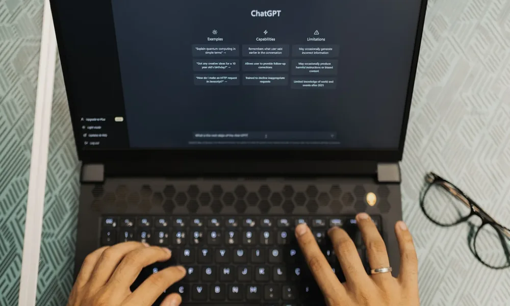 Person using ChatGPT on a laptop while researching business visibility