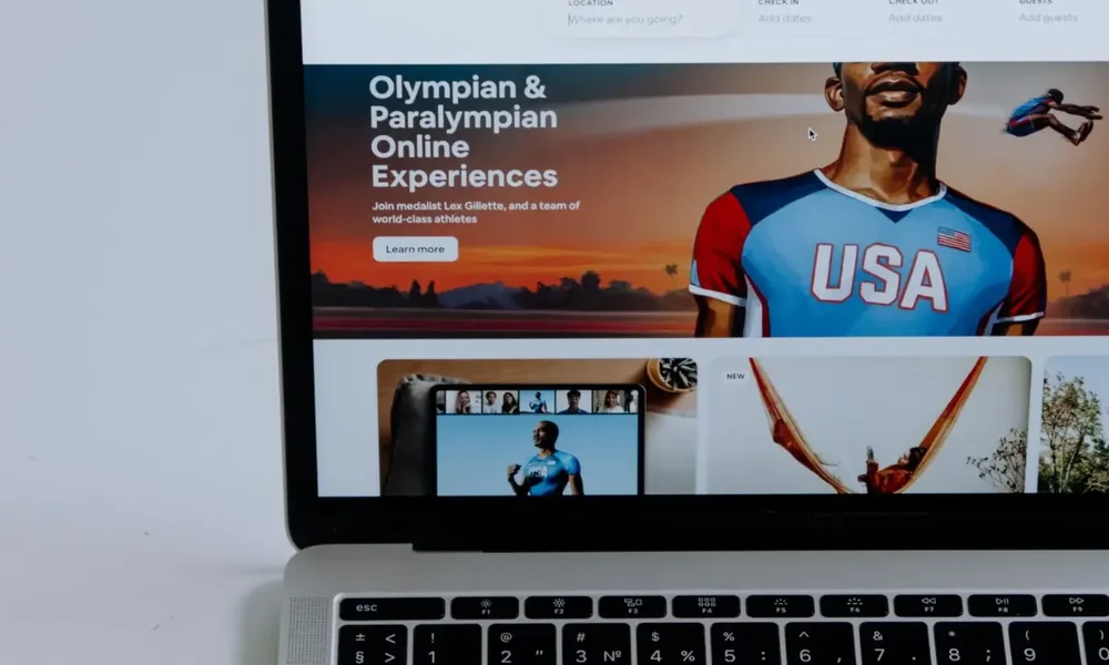 Hands using a laptop while reviewing a website and its conversion journey